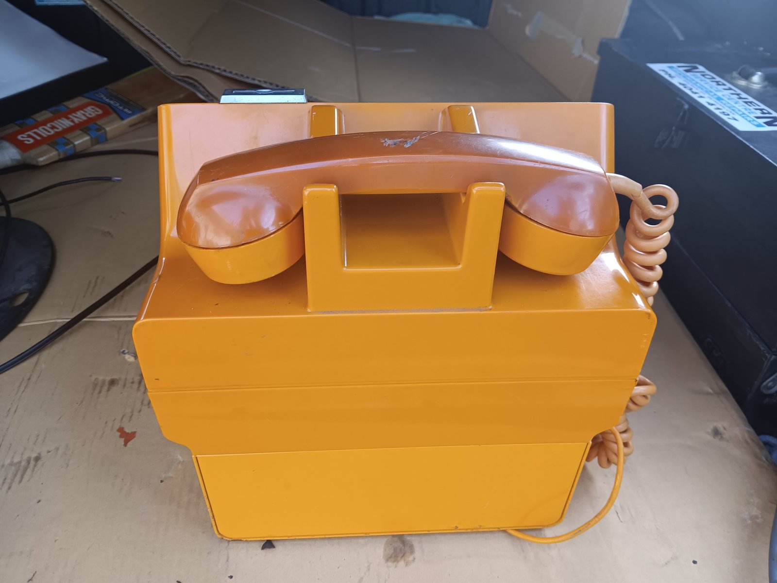 Gold Phone payphone - rear view with handset on cradle (Lot 213)