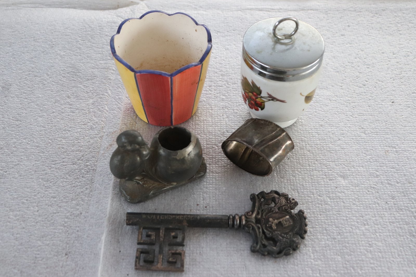 Mixed lot of small vintage items – ceramic planter, lidded jar, decorative key, napkin ring and bird-and-pot metal piece (Lot 218)