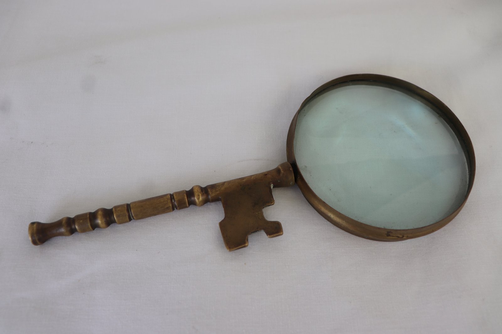 Close-up showing bevelled glass lens and antique patina