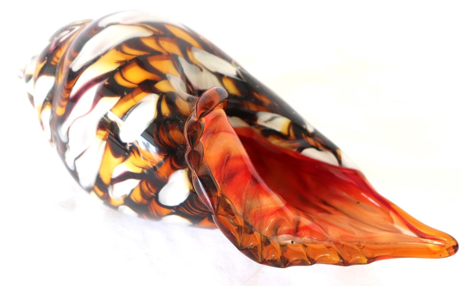 Art glass conch shell with red interior and amber white swirl exterior