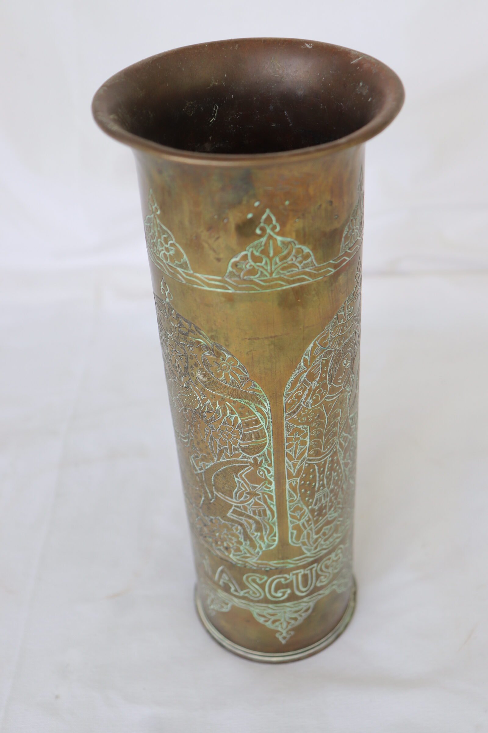 Tall engraved trench art brass shell casing vase with floral and animal motifs