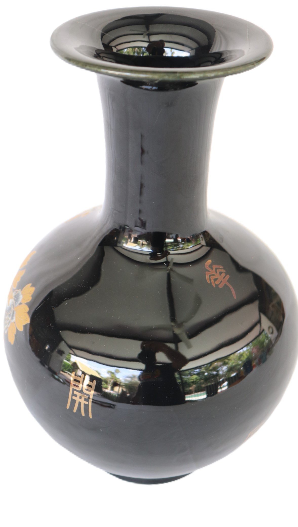 black vase with gold floral design