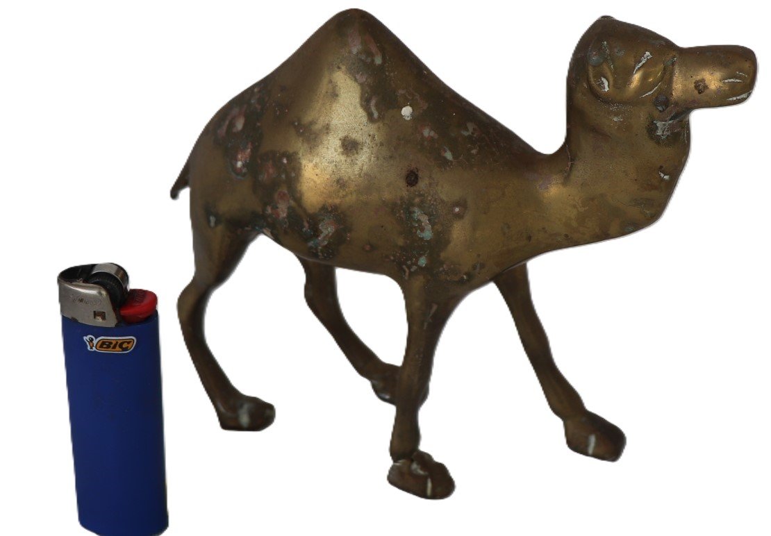 Brass camel figurine with lighter for scale