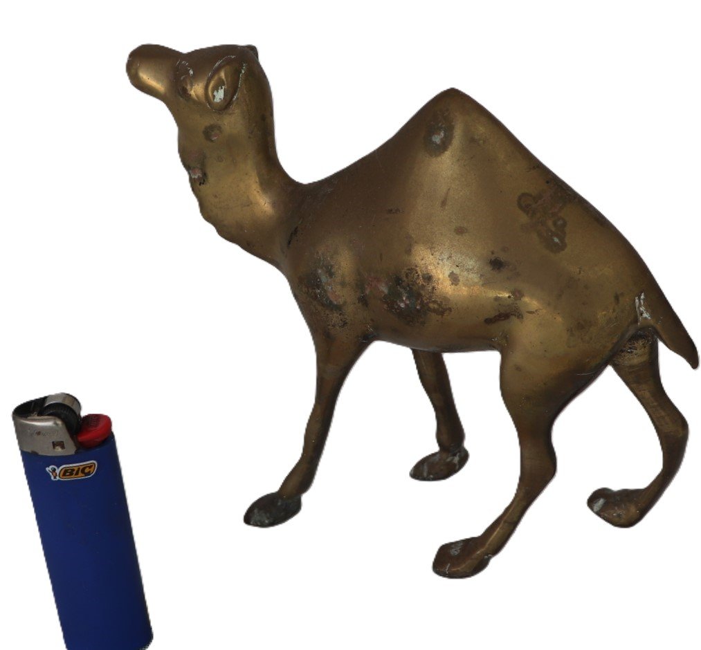 Side view of brass camel ornament