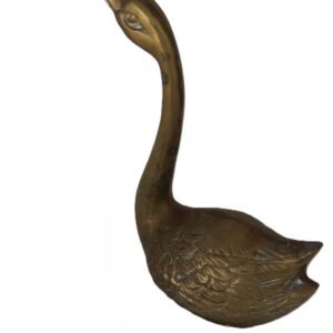 Brass swan figurine with lighter for scale