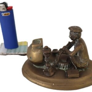 bronze figurine of craftsman seated beside forge and tools