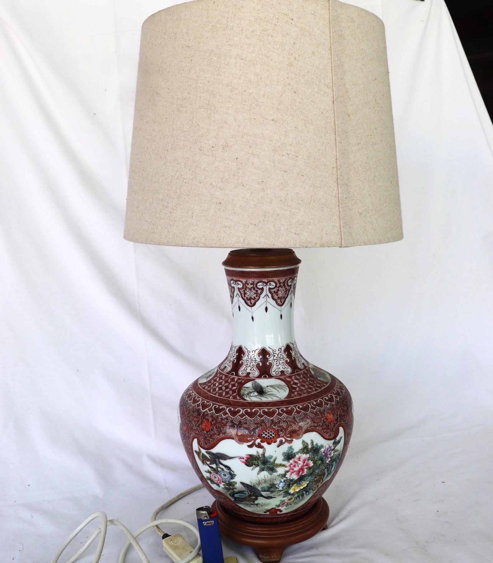 close-up of ceramic lamp base with red and white decorative panels