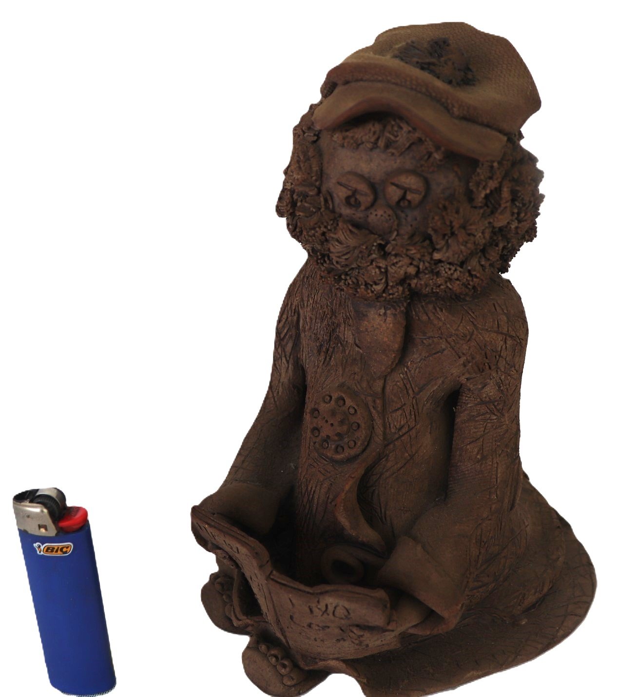 handcrafted clay figure with textured robe and curly hair