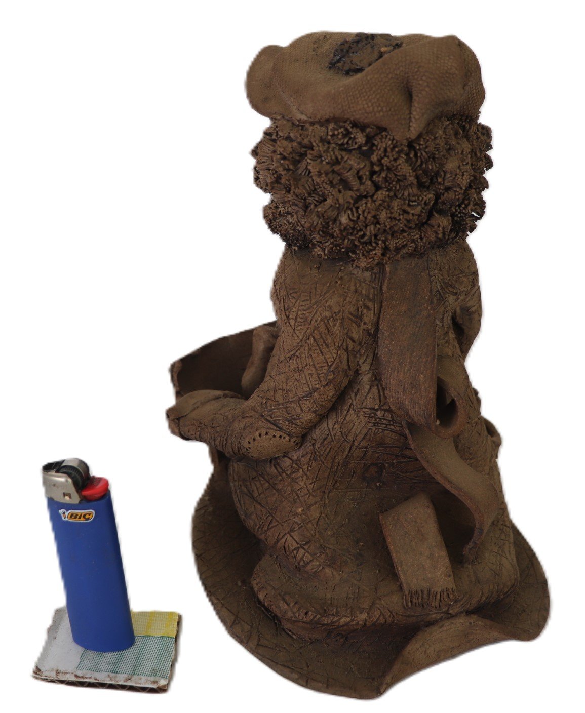 side view of artisan clay sculpture showing robe detail