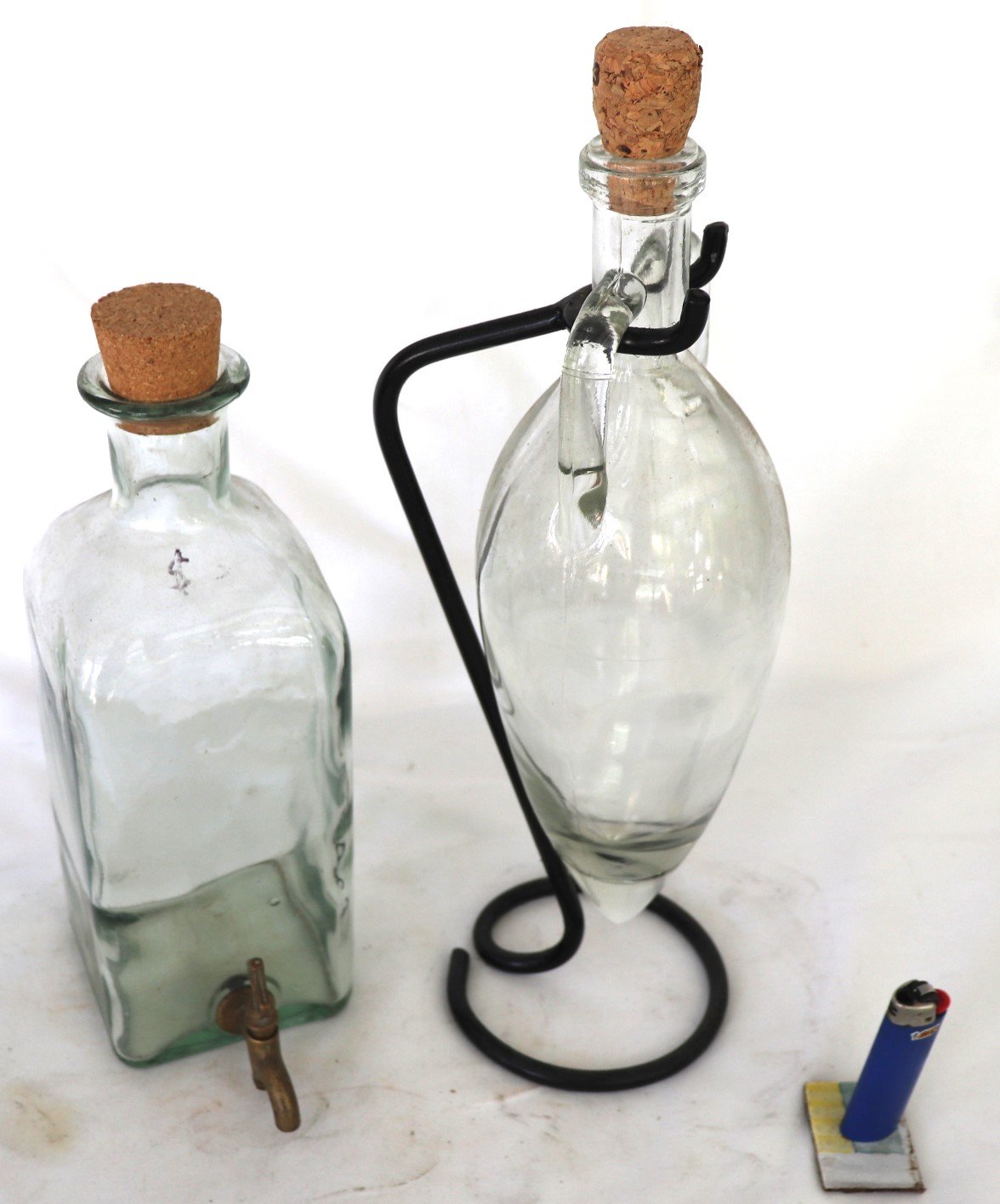 Pair of vintage glass dispensers with cork tops and metal stand