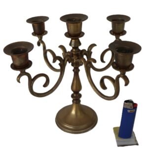 Vintage brass five-arm candelabra with ornate scrolling arms and aged patina