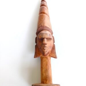 Hand-carved hardwood figure with tall stepped/conical headdress.