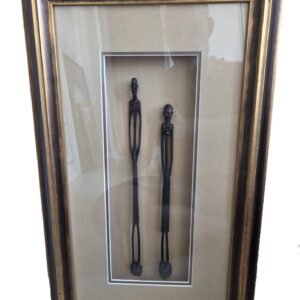 Framed pair of elongated carved tribal figures