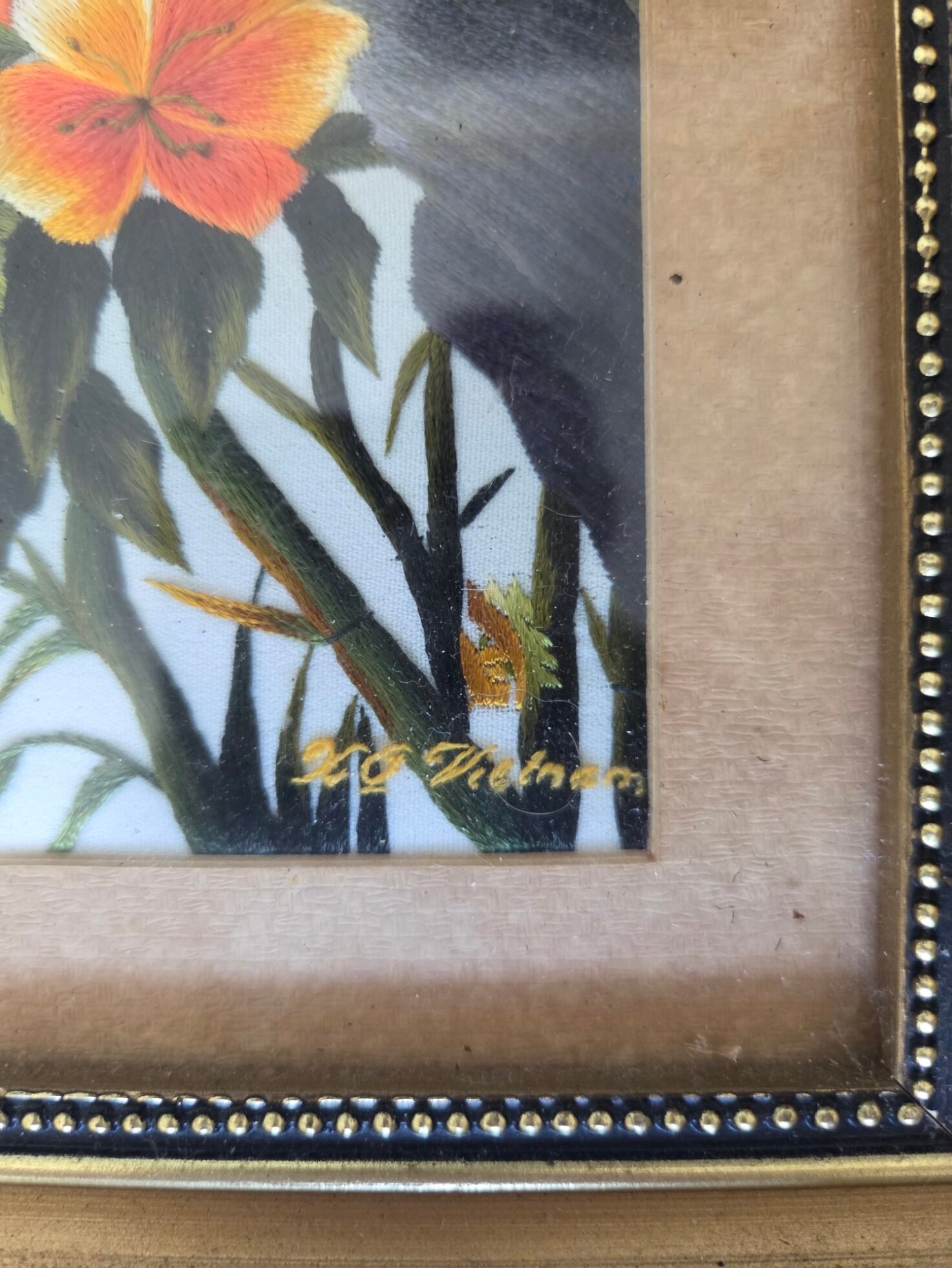 Close-up of signed silk embroidery details