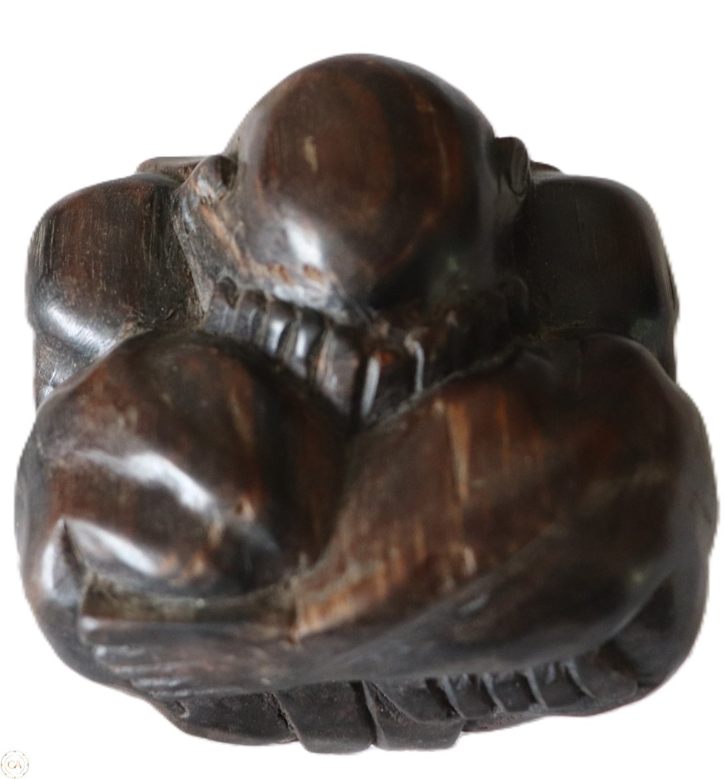 hand carved wooden figure curled form