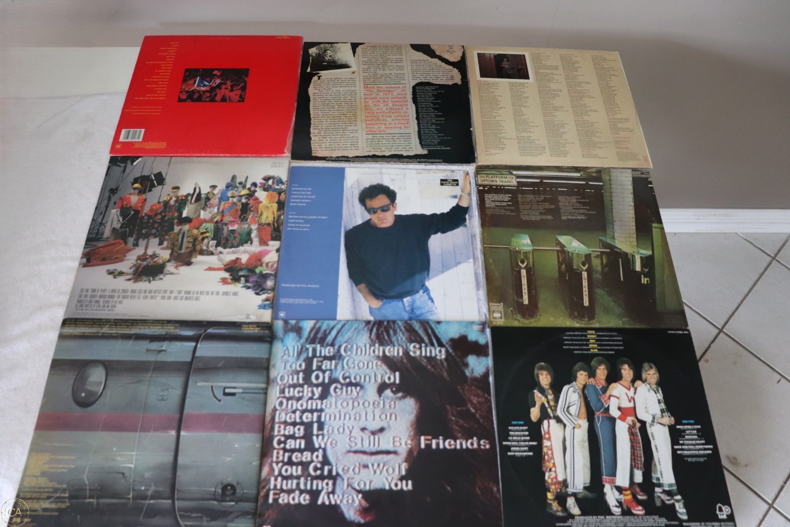 Rear covers showing track lists and album details