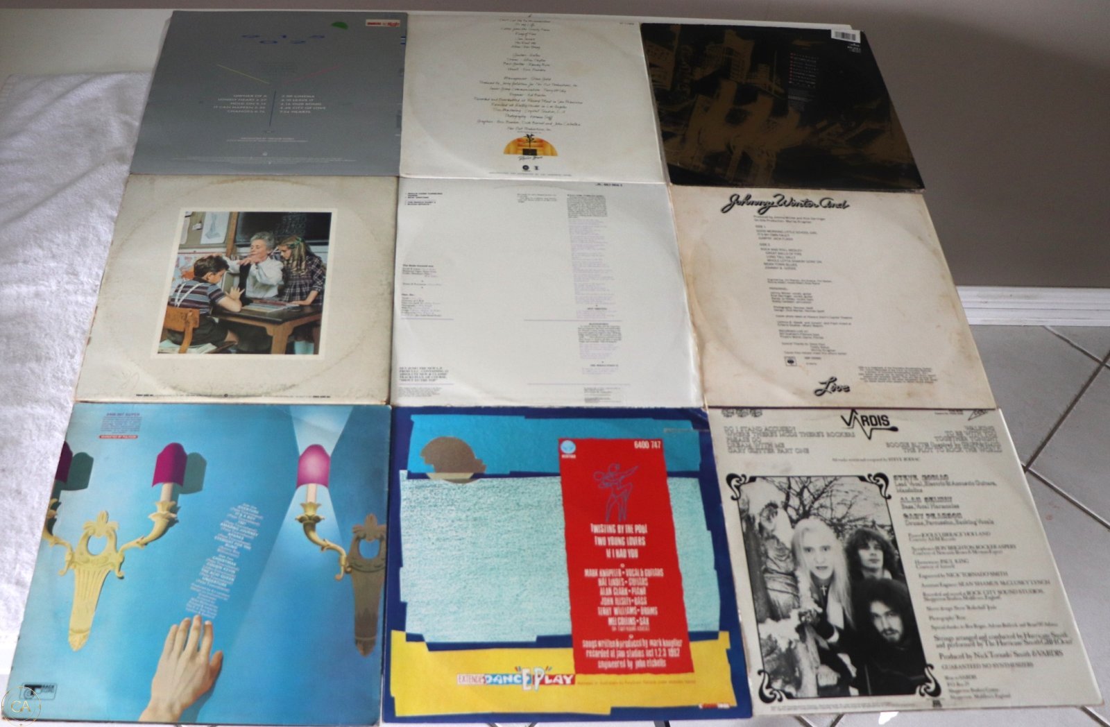 Rear covers showing track lists and album details