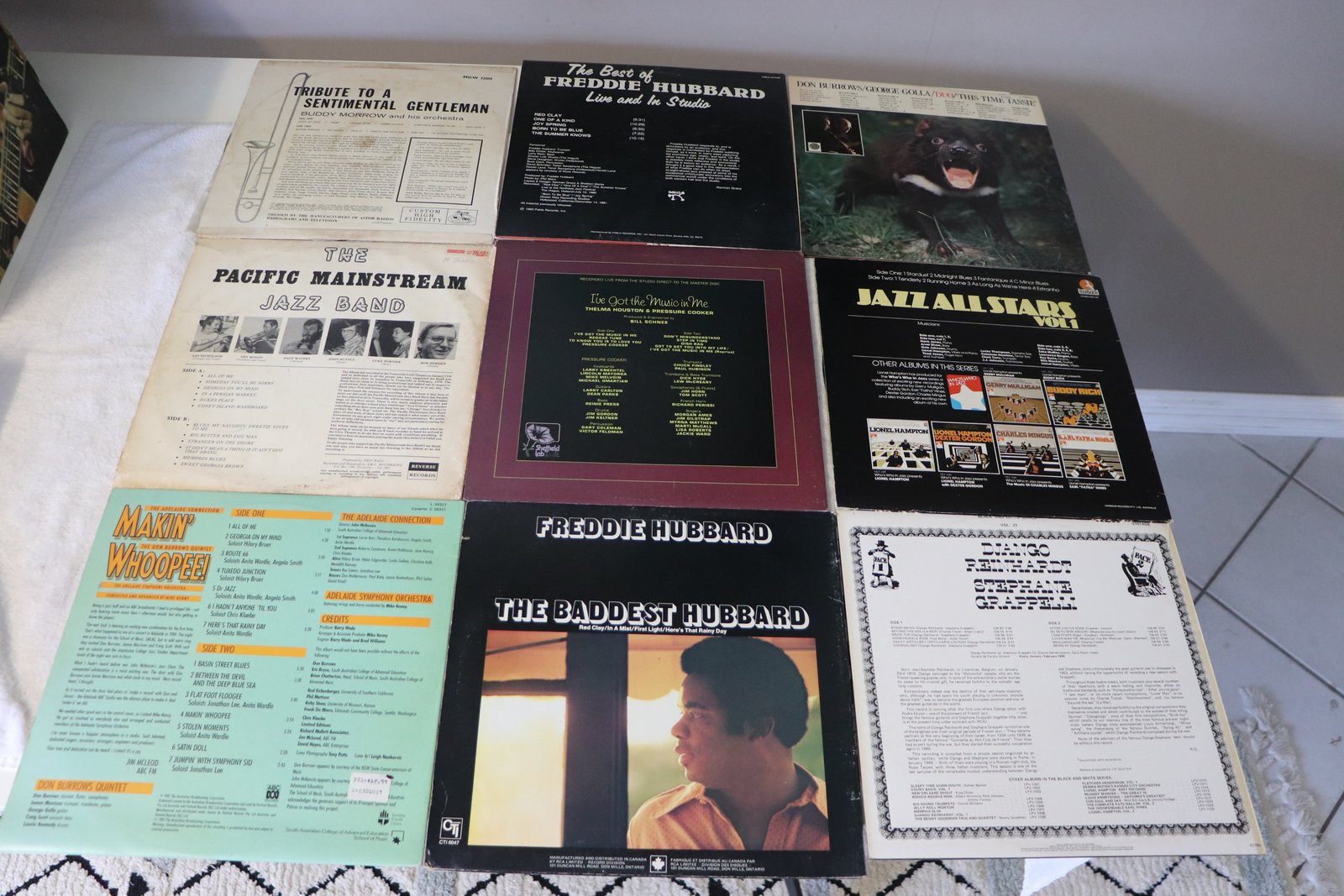 Back covers of nine classic jazz vinyl records showing liner notes and track listings