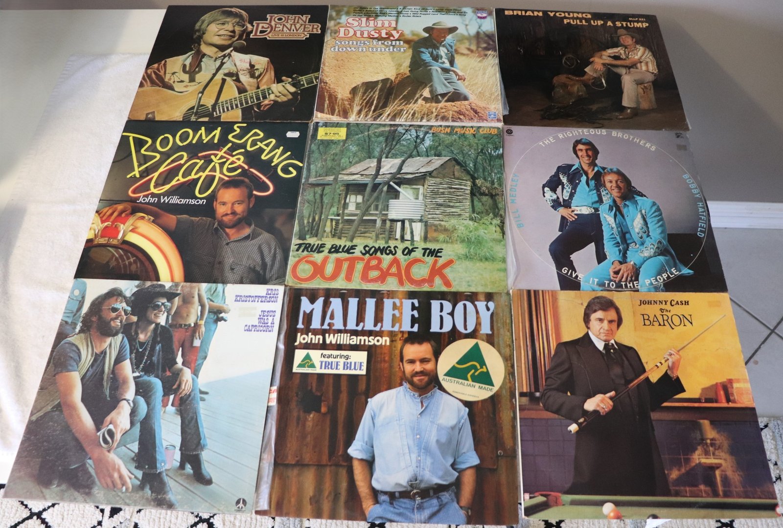 Front covers of nine country and outback themed vinyl albums featuring John Williamson, Slim Dusty, and Johnny Cash
