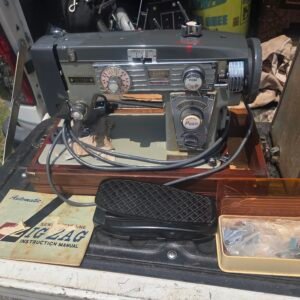 Universal Dial-A-Stitch vintage sewing machine with accessories