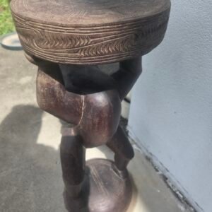 Carved tribal wooden figure stool front view