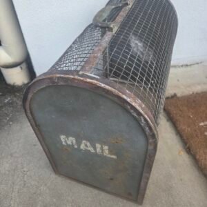 Vintage industrial metal mesh mail bin with hinged door and original MAIL stencil