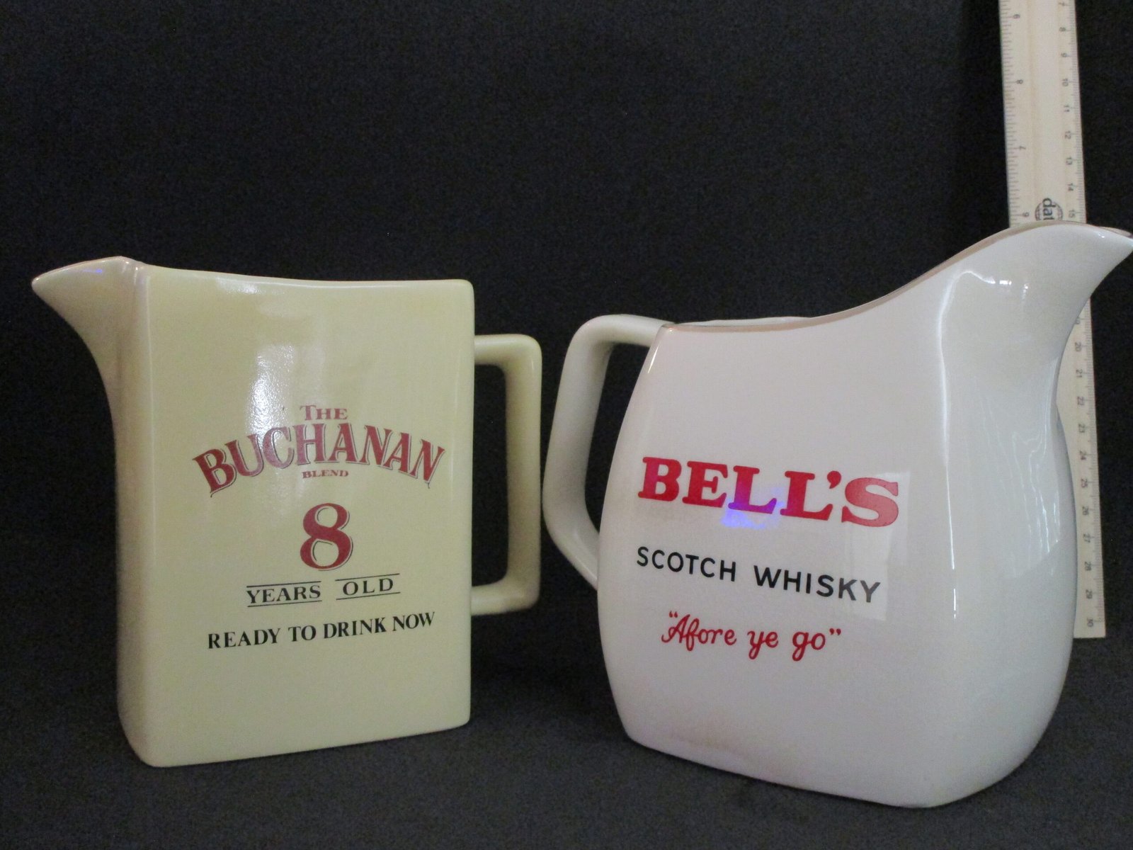 Pair of vintage whisky advertising water jugs