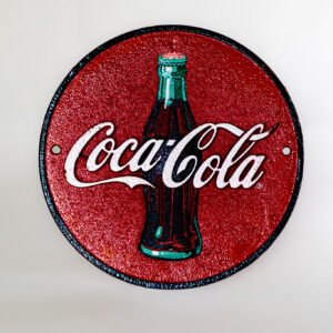Vintage Coca-Cola cast iron round wall sign front view
