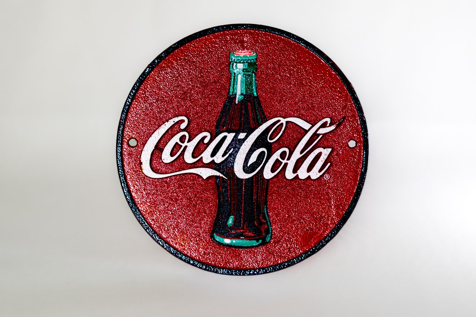 Vintage Coca-Cola cast iron round wall sign front view